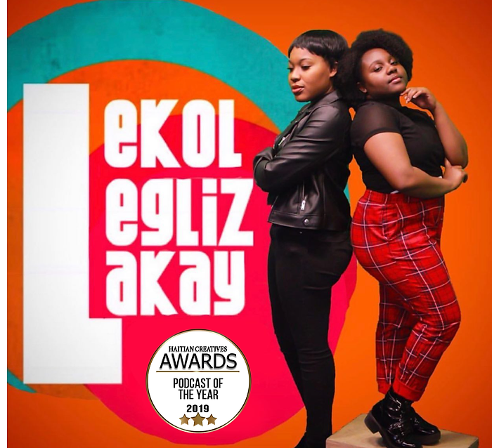 Red,green, and orange backkground and white lettering to the left that reads "Lekol, Legliz, lakay"  on the left of the image and on the right two women of african decent back to back. the woman on the left low cut with black leather jacked and black pants, woman on the left of her has a afro, short sleve black shirt, and red pattern print pants. 