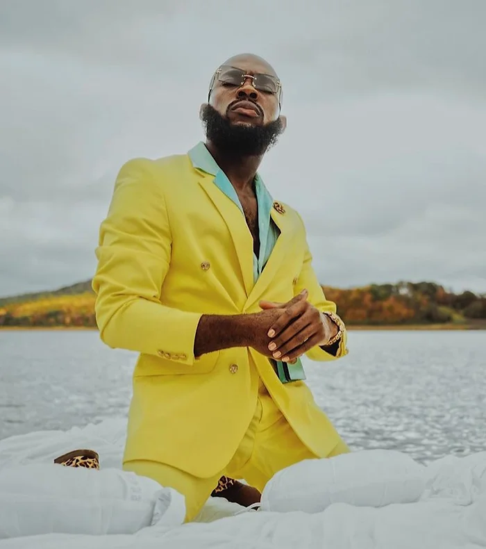 man with yellow blazer on the beach