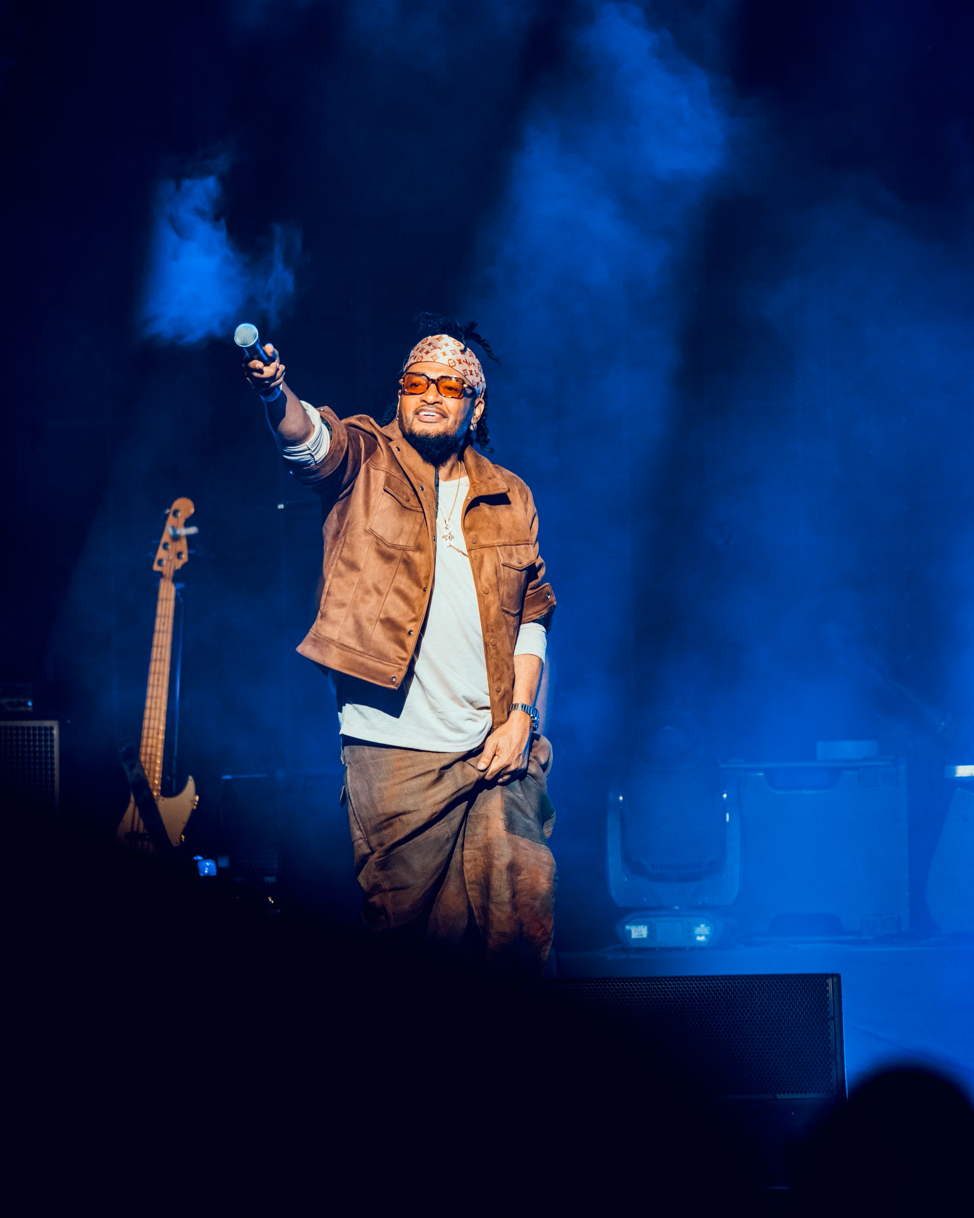 Alan cave on stage with a microphone to the audience at Madison Square Garden